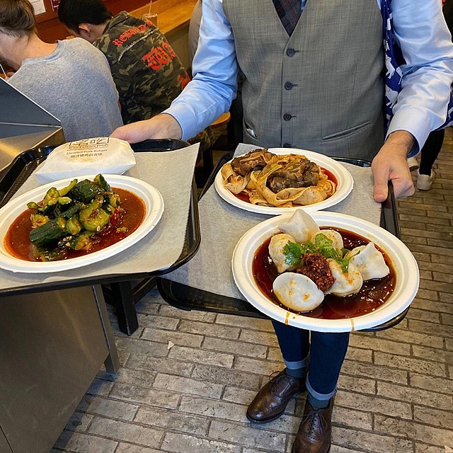 Waiter Bringing Out Food At A Restaurant